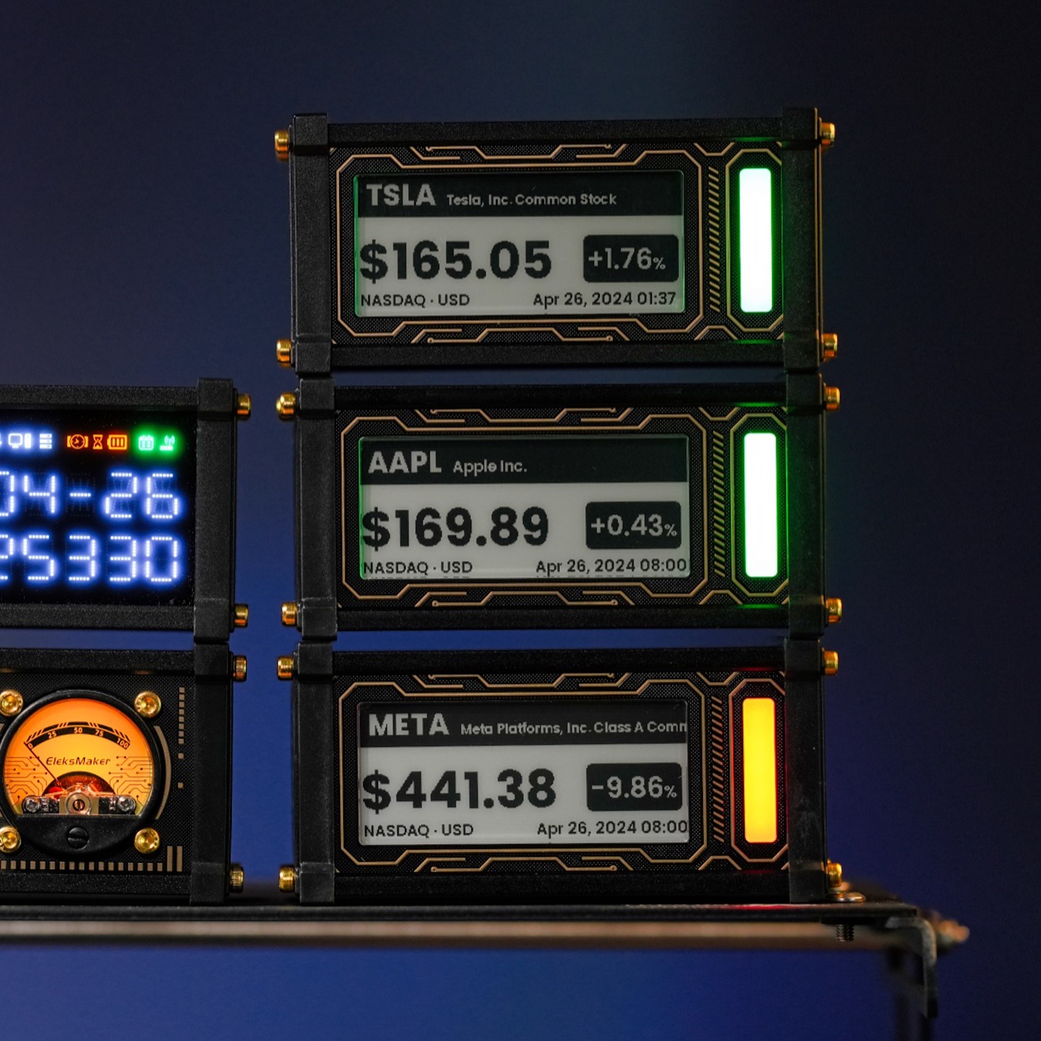 Three EleksCava units stacked showing TSLA, AAPL, and META stock prices