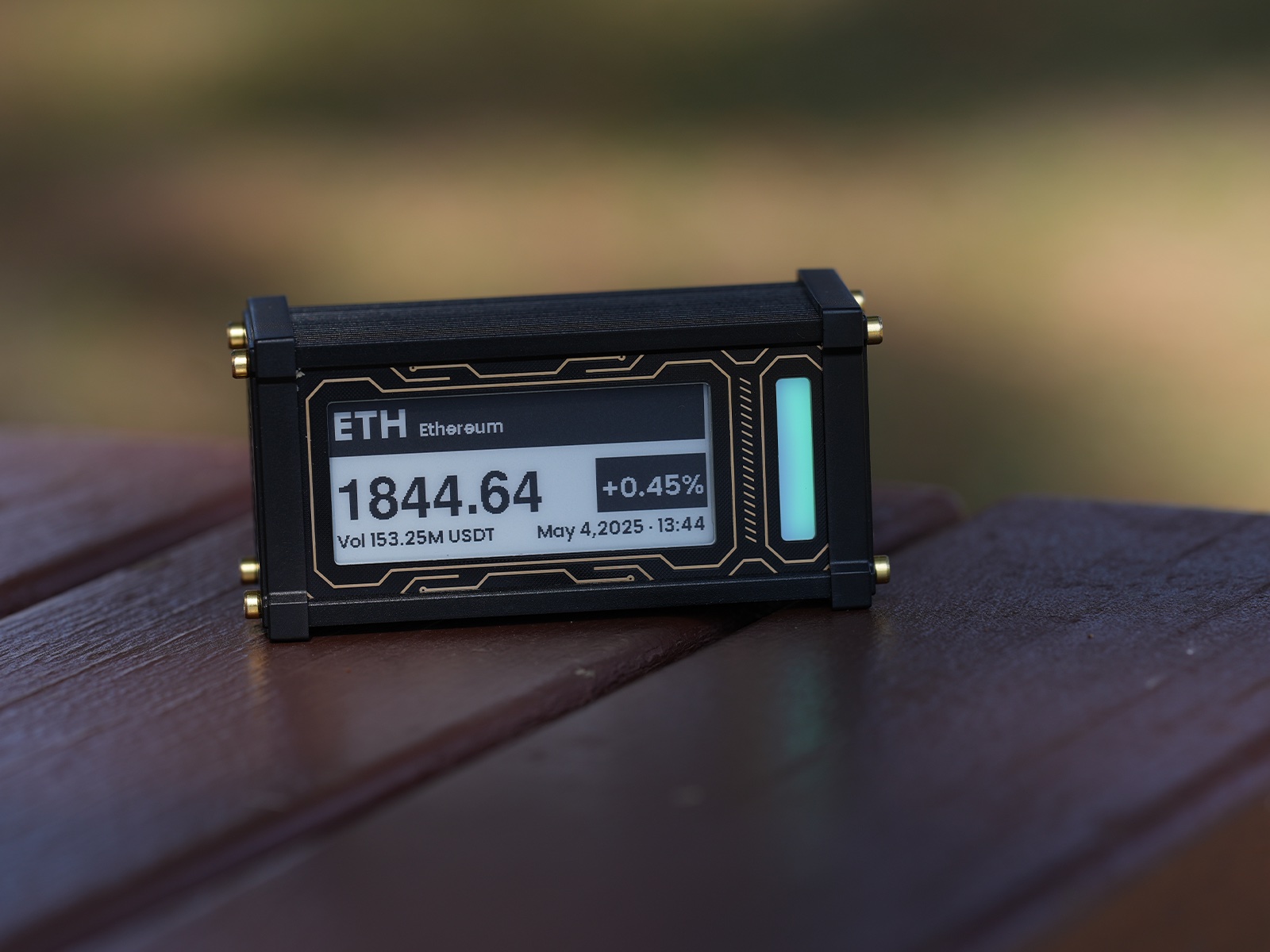 EleksCava displaying Ethereum price on a wooden desk at golden hour